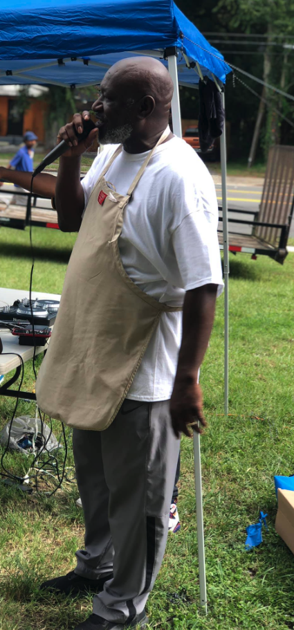 Pastor LeCount speaking at an outdoor community event